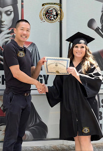 Louisville Beauty Academy founder Di Tran congratulating a 2026 graduate in cap and gown