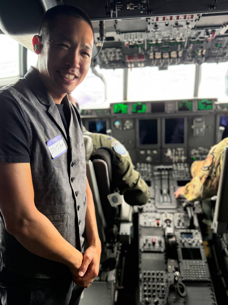 Di Tran inside a C-130 cockpit during the ESGR Air Guard Boss Lift 2026 with Kentucky Air Guard personnel visible at the controls.