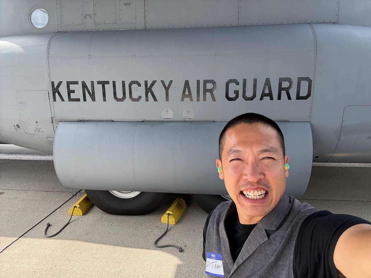 Di Tran standing beside a Kentucky Air Guard C-130 aircraft during the ESGR Air Guard Boss Lift 2026 in Louisville, Kentucky.