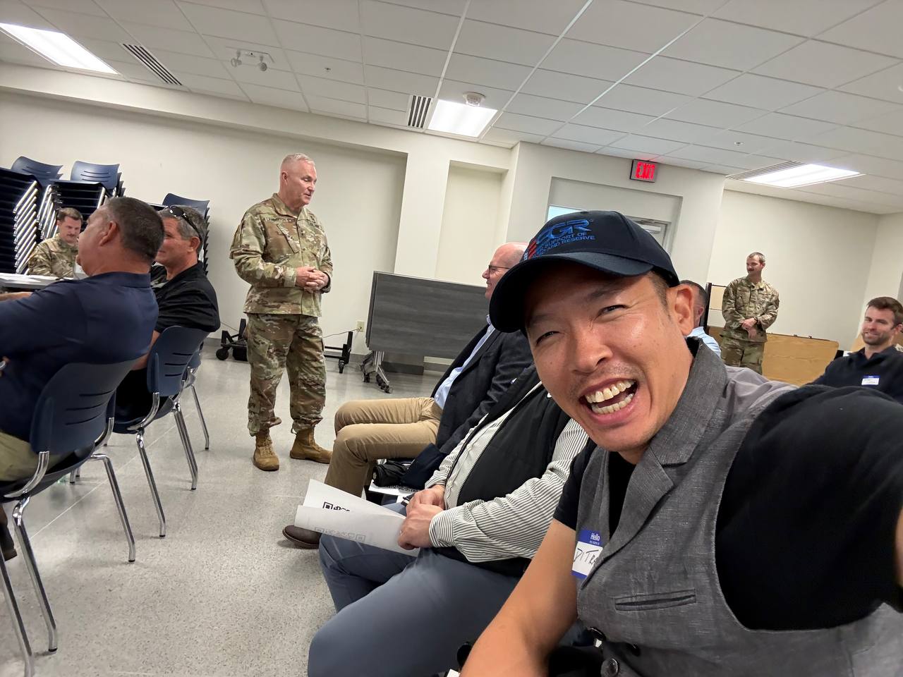 Di Tran attending an ESGR Air Guard Boss Lift 2026 briefing with uniformed Kentucky Air Guard personnel and community participants.